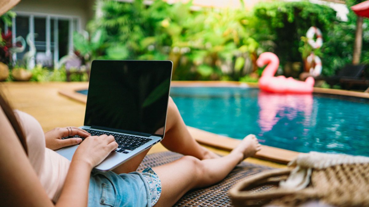 woman working remotely from pool